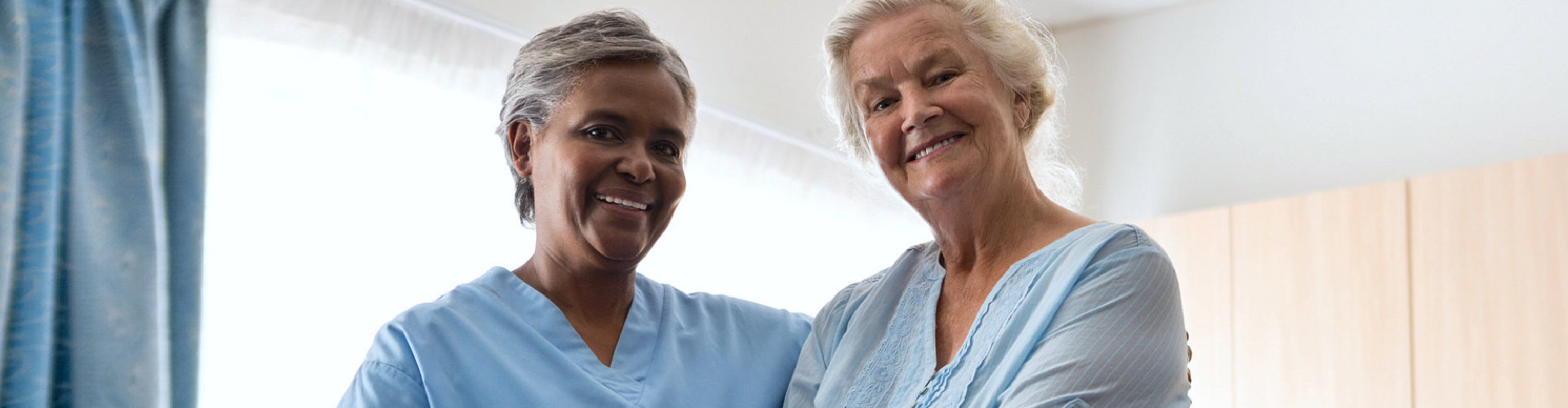 caregiver and senior woman smiling